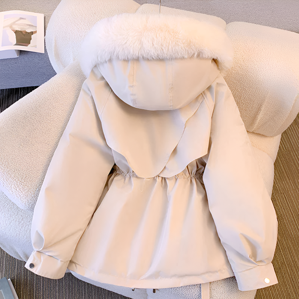 Women's winter jacket with hood, tailored fit, zippered pockets, and elegant silhouette