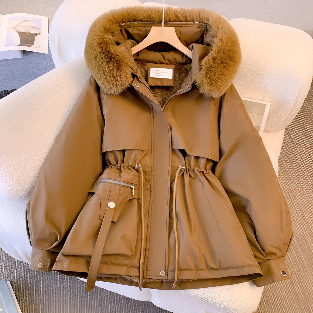 Women's winter jacket with hood, tailored fit, zippered pockets, and elegant silhouette